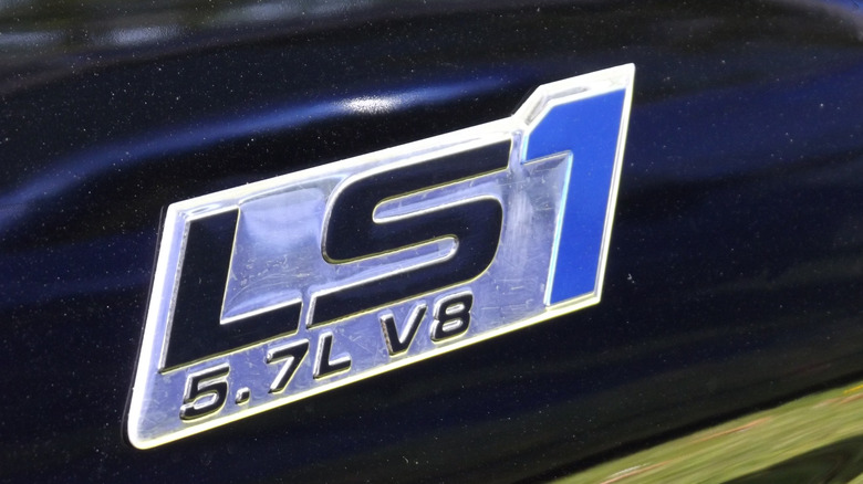 A closeup of the LS1 5.7L V8 badge on the side of a General Motors vehicle