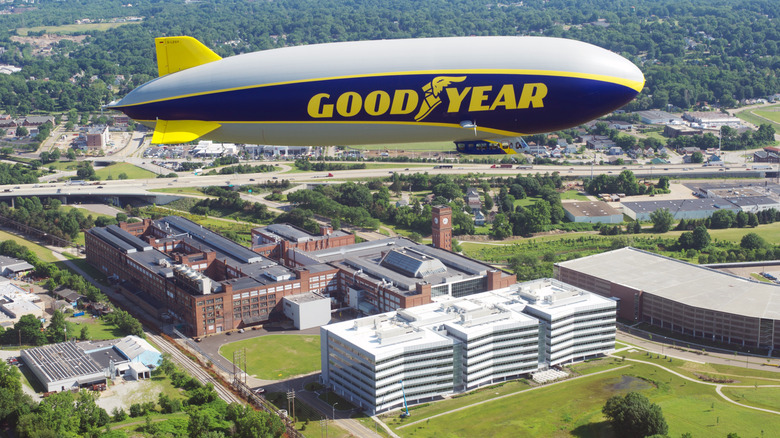 A Goodyear Blimp flying over the Goodyear headquarters in Akron, Ohio