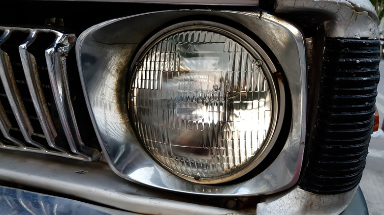 A sealed-beam headlight on an old car