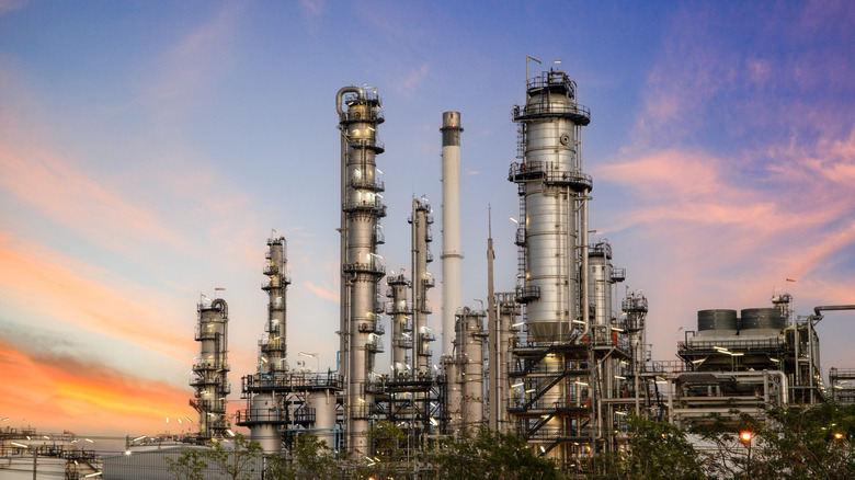 An oil refinery against a sunset sky