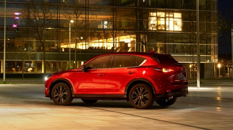 Mazda CX-5 in red parked in front of an office building at night