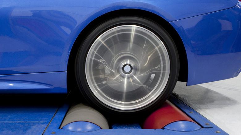 Close up of rear wheel on blue car on a chassis dynamometer