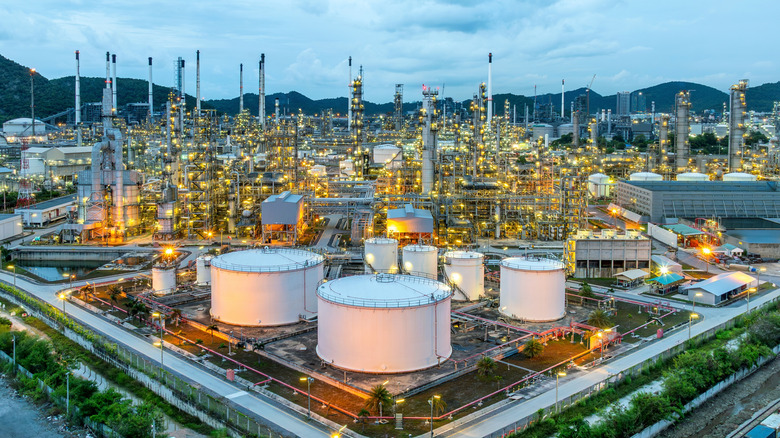 A sprawling oil refinery with lights illuminated