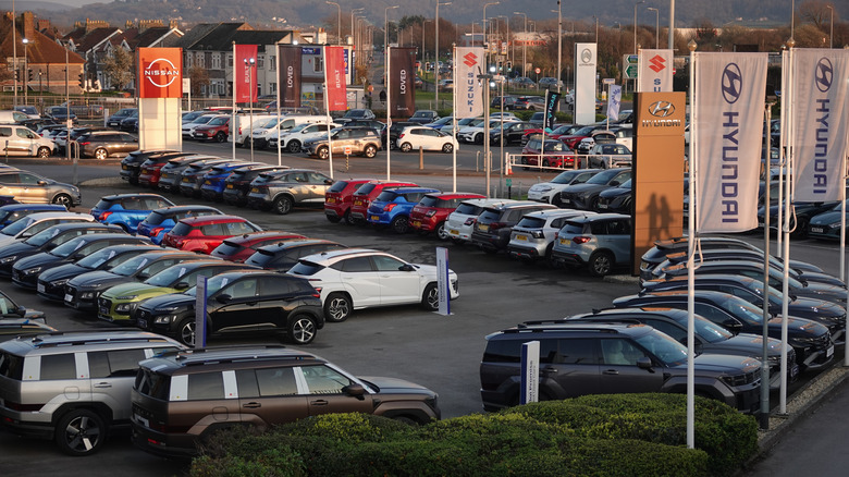 An auto dealership parking lot where they sell multiple brands.