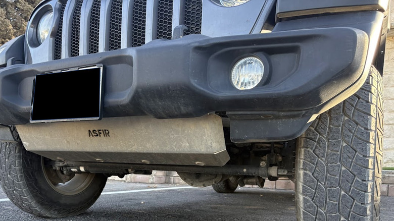 A JL Jeep Wrangler with an aftermarket ASFIR skid plate.