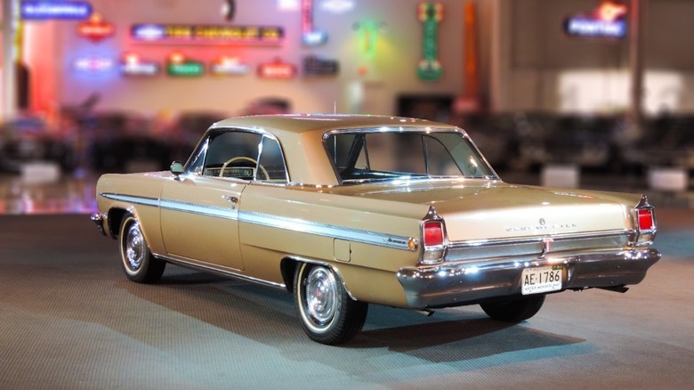 A rear three-quarter view of the Oldsmobile Jetfire sitting in a museum.