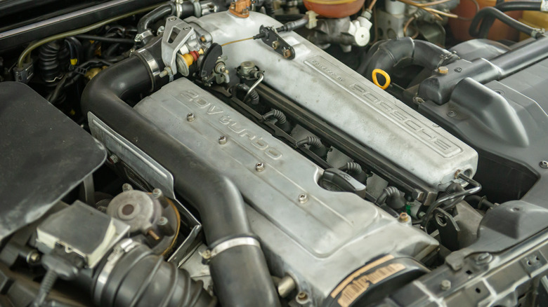 The engine of an Audi RS2 showing Porsche badging on its intake manifold.