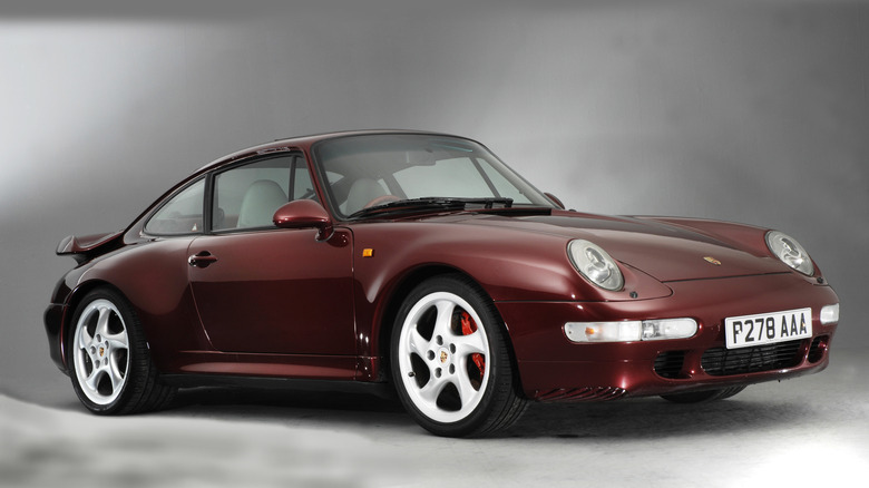 Maroon Porsche 993 parked in a museum.