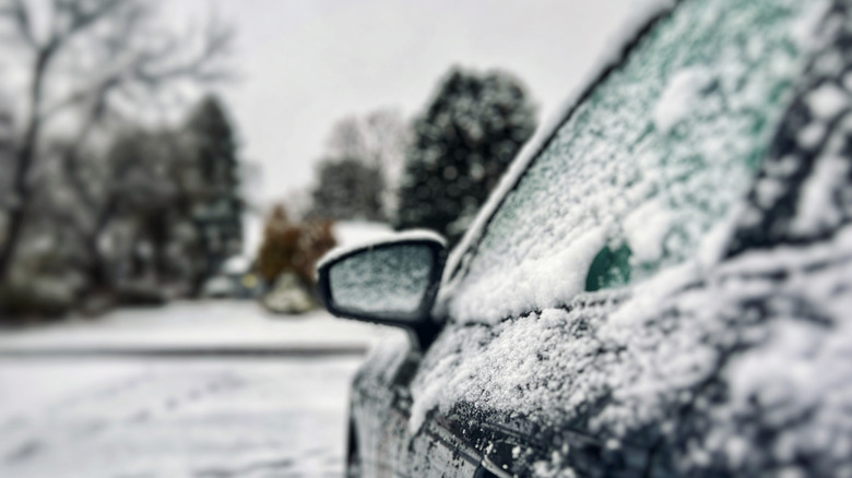 A black car covered in snow