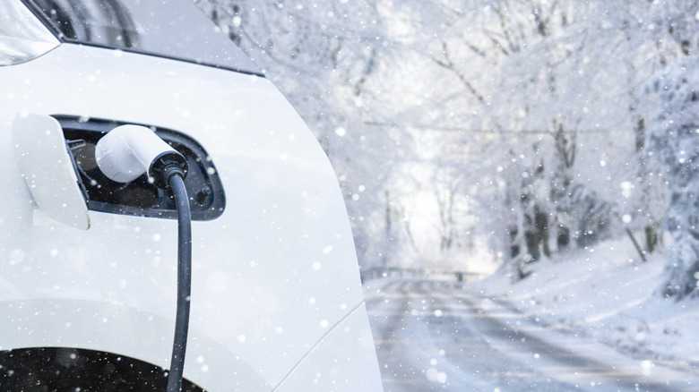 Electric vehicle plugged in with a snowy background