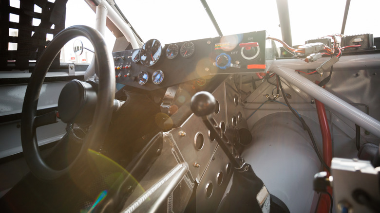 A racing car cockpit with a manual gear shifter