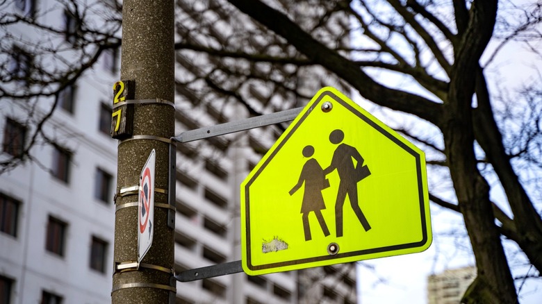 A sign cautions driver to pay extra attention in a school zone for pedestrians