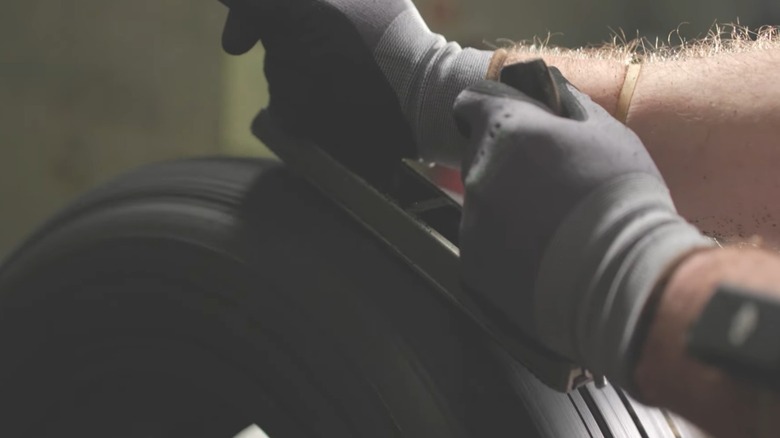 Technician shaving tire