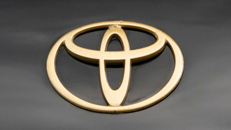 A gold Toyota emblem on a MK4 Supra