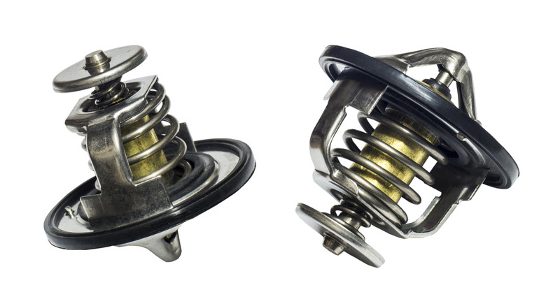 Two car thermostats on a white background.