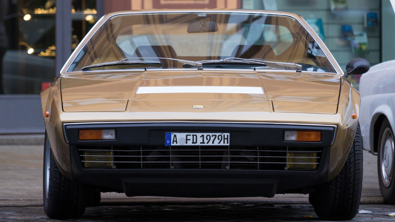 A Ferrari Dino 208 GT4 parked on the street