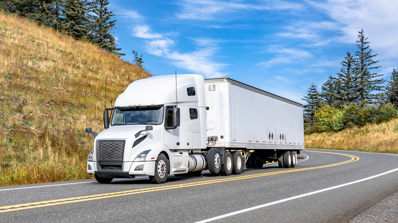Industrial white big rig long haul semi truck with extended cab