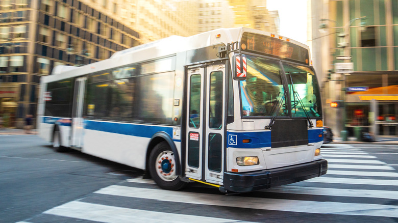A New York City metro bus making a left-hand turn.