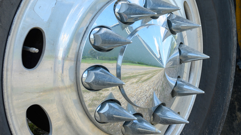 A truck wheel with custom pointed and shiny lug nuts