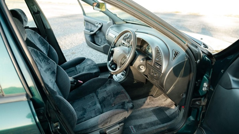 A photo of the Xsara's front seats and dashboard with both front doors open