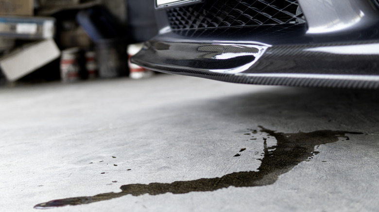 Engine oil stains of car Leak under the car when the car is park on the road service