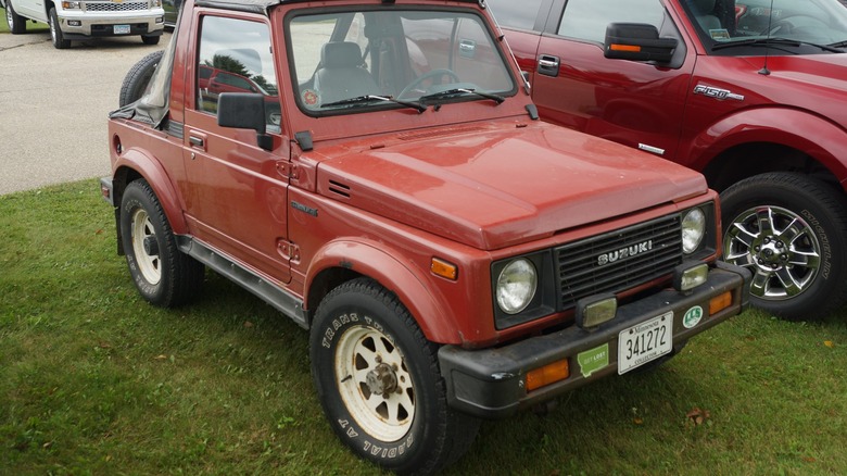 A red 1987 Suzuki Samurai at a car show