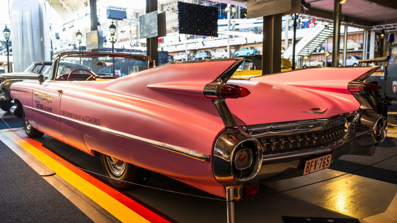 A pink 1959 Cadillac Eldorado convertible in a car museum
