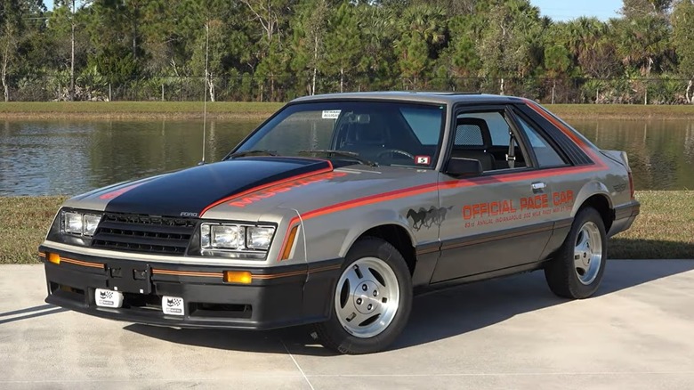 A 1979 Ford Mustang Indy 500 Pace Car replica parked on the grounds of the American Muscle Car Museum
