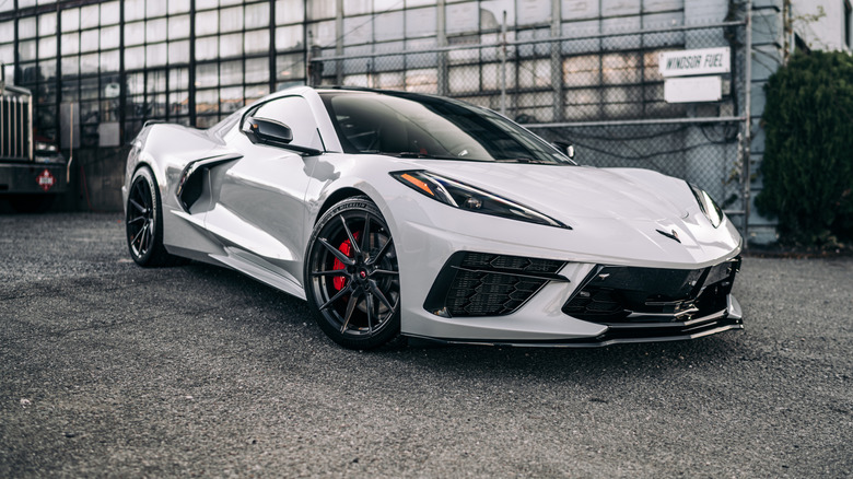 White Corvette parked outside.