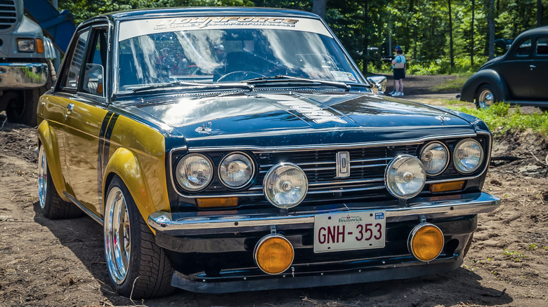 A 1969 Datsun 510 in a field in Canada