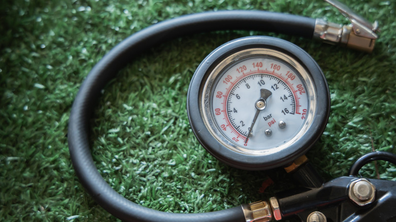 An air compressor on a green grass carpet