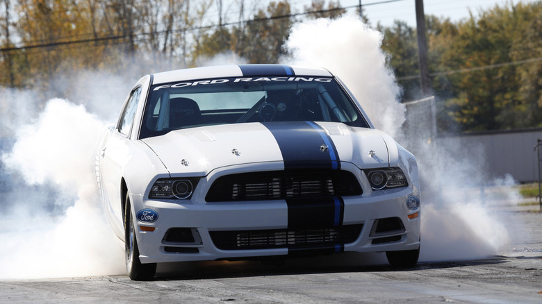 A 2012 Ford Mustang Cobra Jet doing a burnout