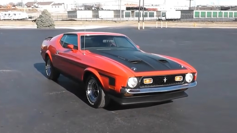 Front 3/4 of red 1971 Ford Mustang Boss 351 with black hood