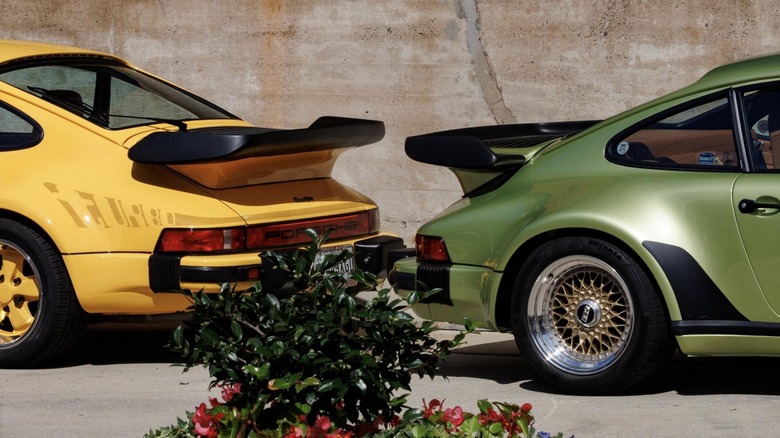 The rear ends of two Porsche 930 Turbos