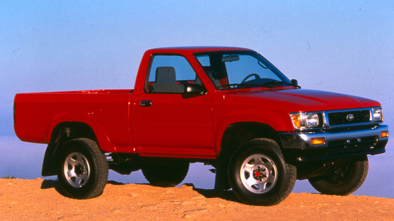 A red 1993 Toyota Truck sits parked outdoors.