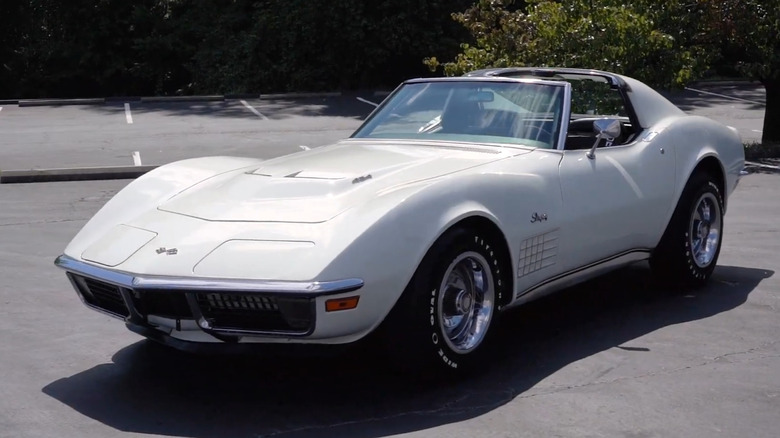 A 1971 Corvette C3 ZR2 T-Top coupe in white on a parking lot.