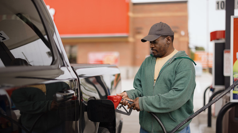 A man prepares to pump gas into his pickup.