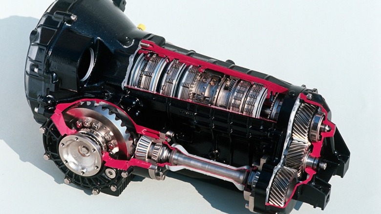 A cutaway of a Porsche Tiptronic gearbox, with red outlining the case and a look inside at its innards.