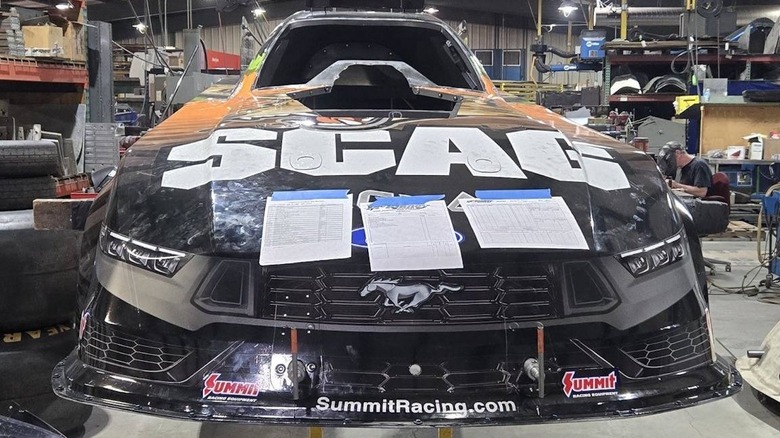 Front view of SCAG Wilkerson Racing's funny car body under repair, preparing for another race weekend