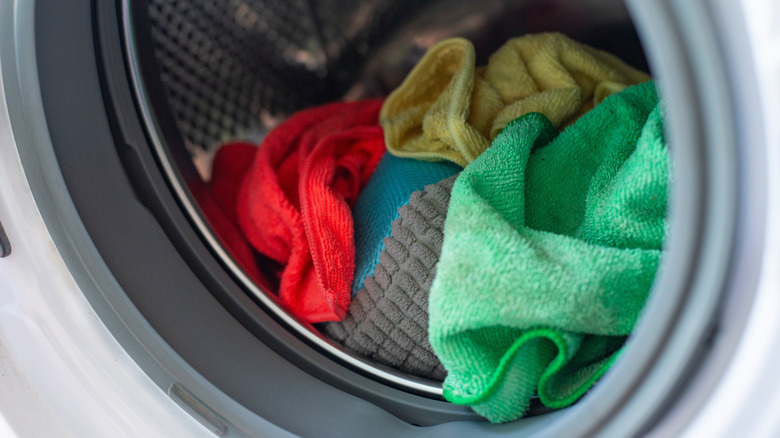 Colorful microfiber towels inside the drum of a washing machine