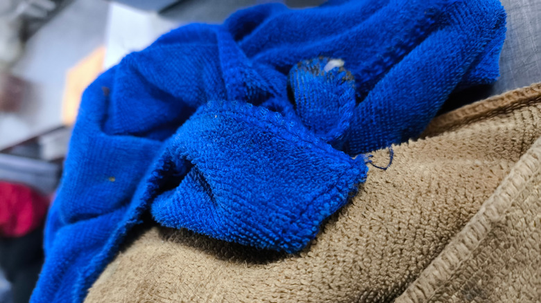A stack of blue and brown microfiber cloths