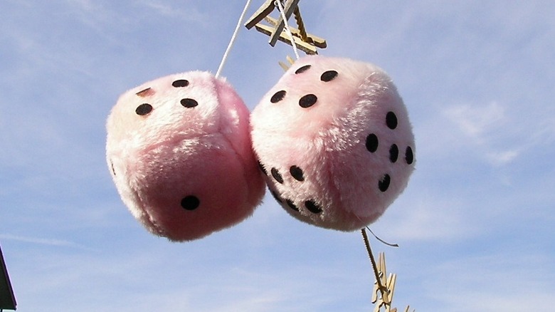 A pair of pink fuzzy dice.