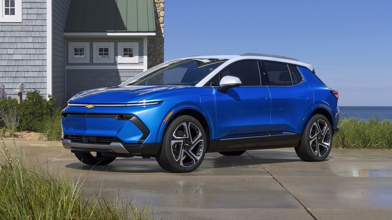 A Chevy Equinox EV in blue near the coast