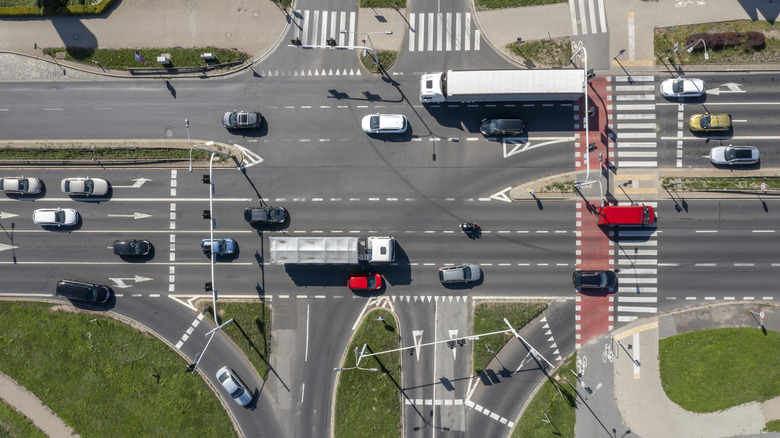 An aerial view of a busy intersection with various vehicles visible.