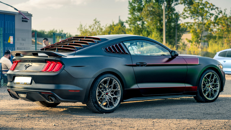 A contemporary Ford Mustang with rear and side panel window louvers.