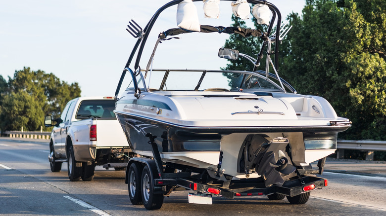 A pickup truck towing a boat.