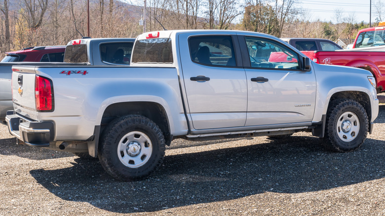 A silver pickup truck in a parking lot