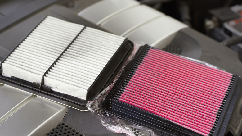 An old clogged air filter against a performance air filter