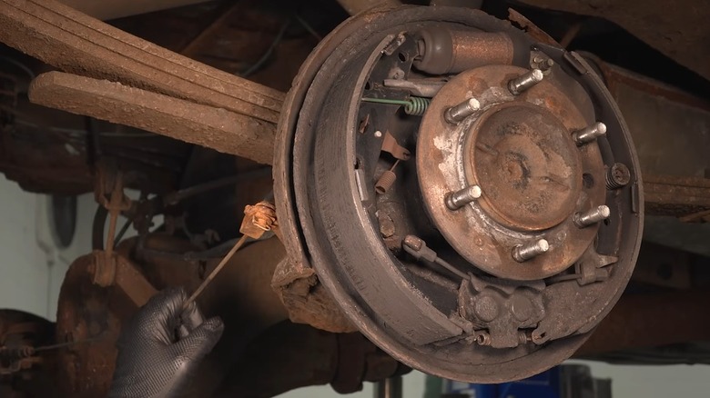 A parking brake system with mechanical line appearing rusty.