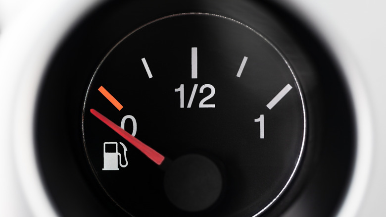 Car fuel gauge pointing to empty